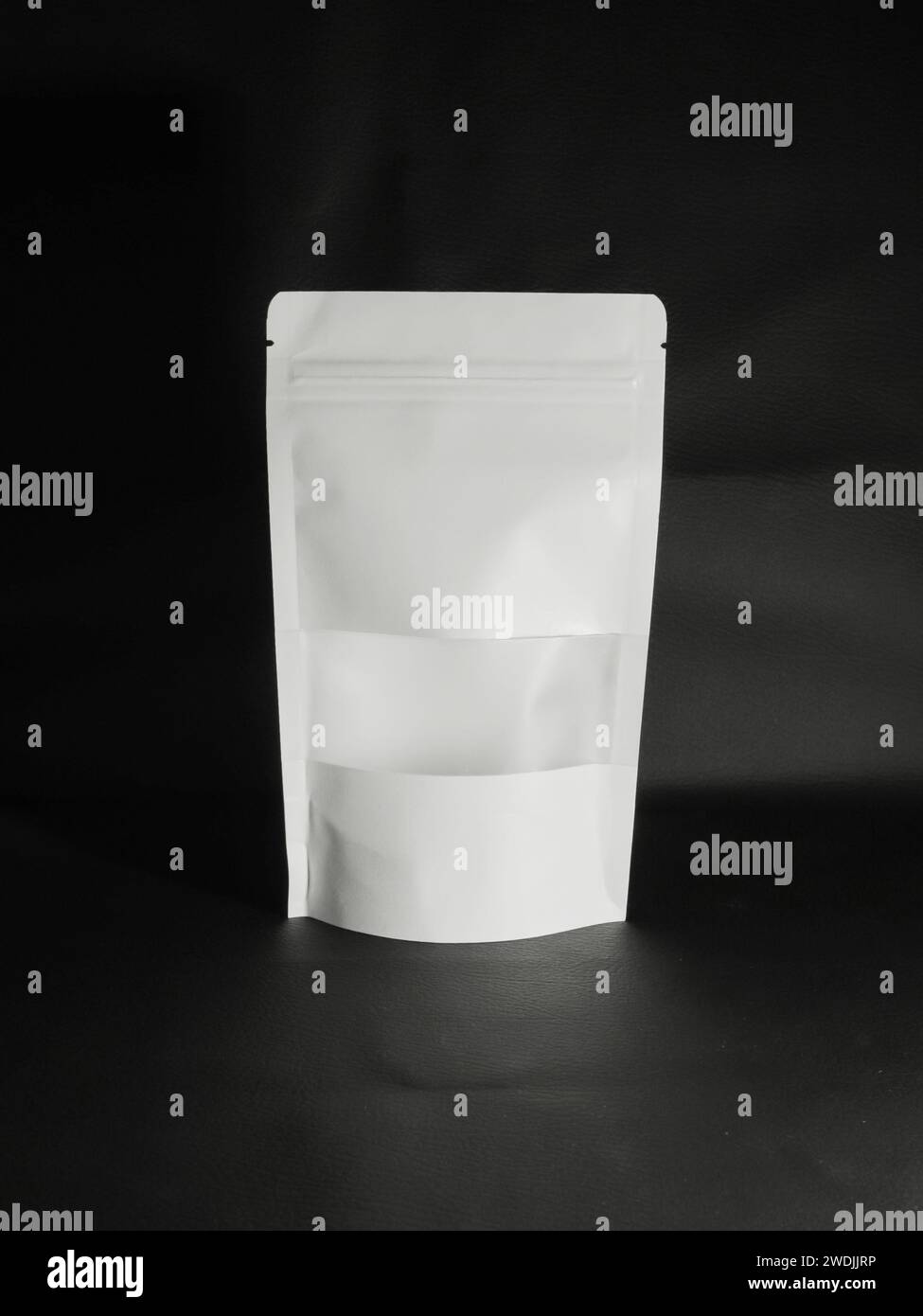 Blank white plastic bag isolated on black background Stock Photo