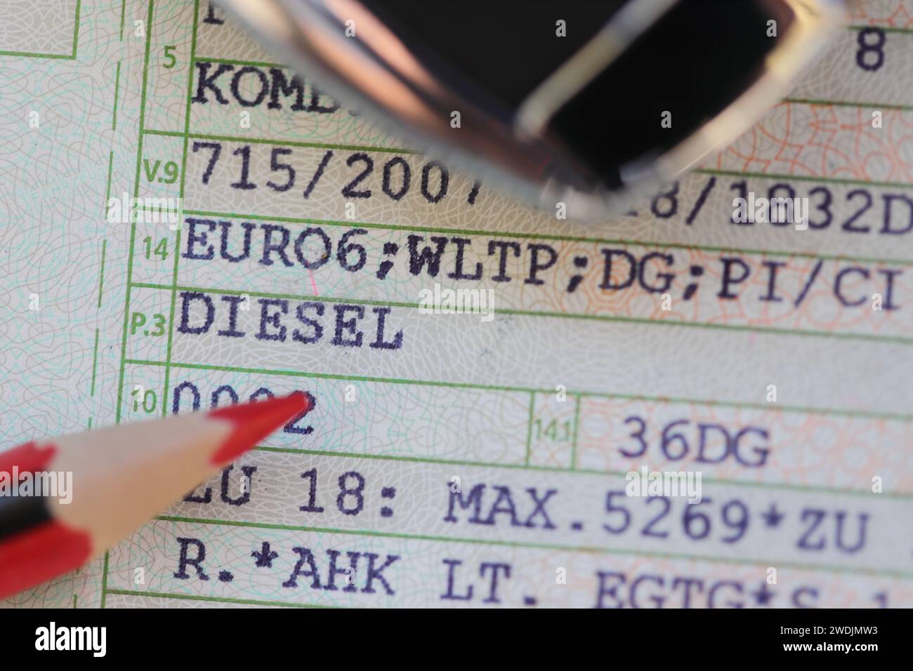 a vehicle registration document with the words (Diesel, Euro 6) and a red pen Stock Photo Alamy