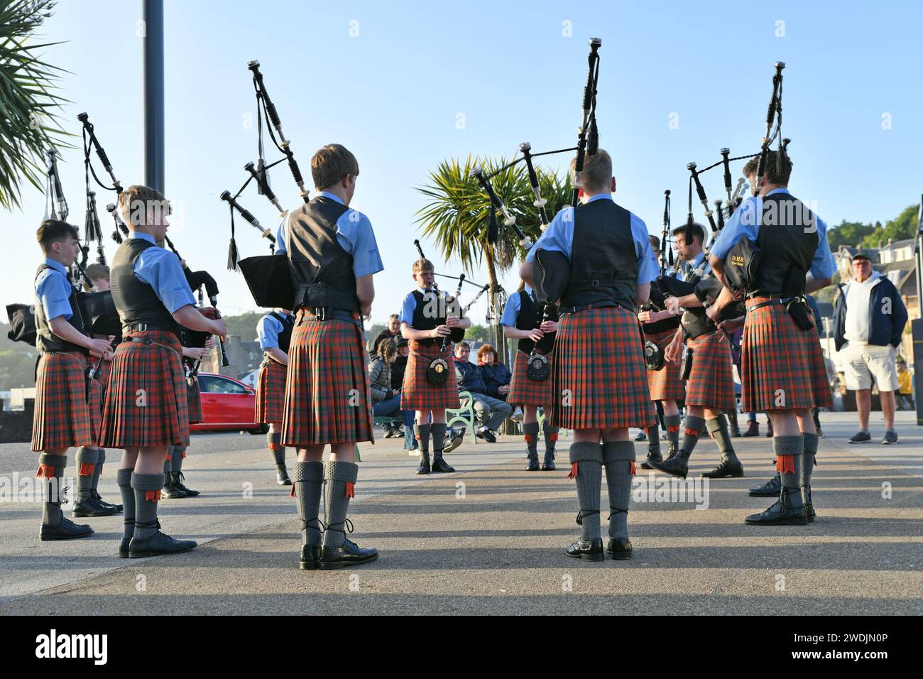 Members of the Oban High School Pipe Band playing in the town centre of Oban Stock Photo