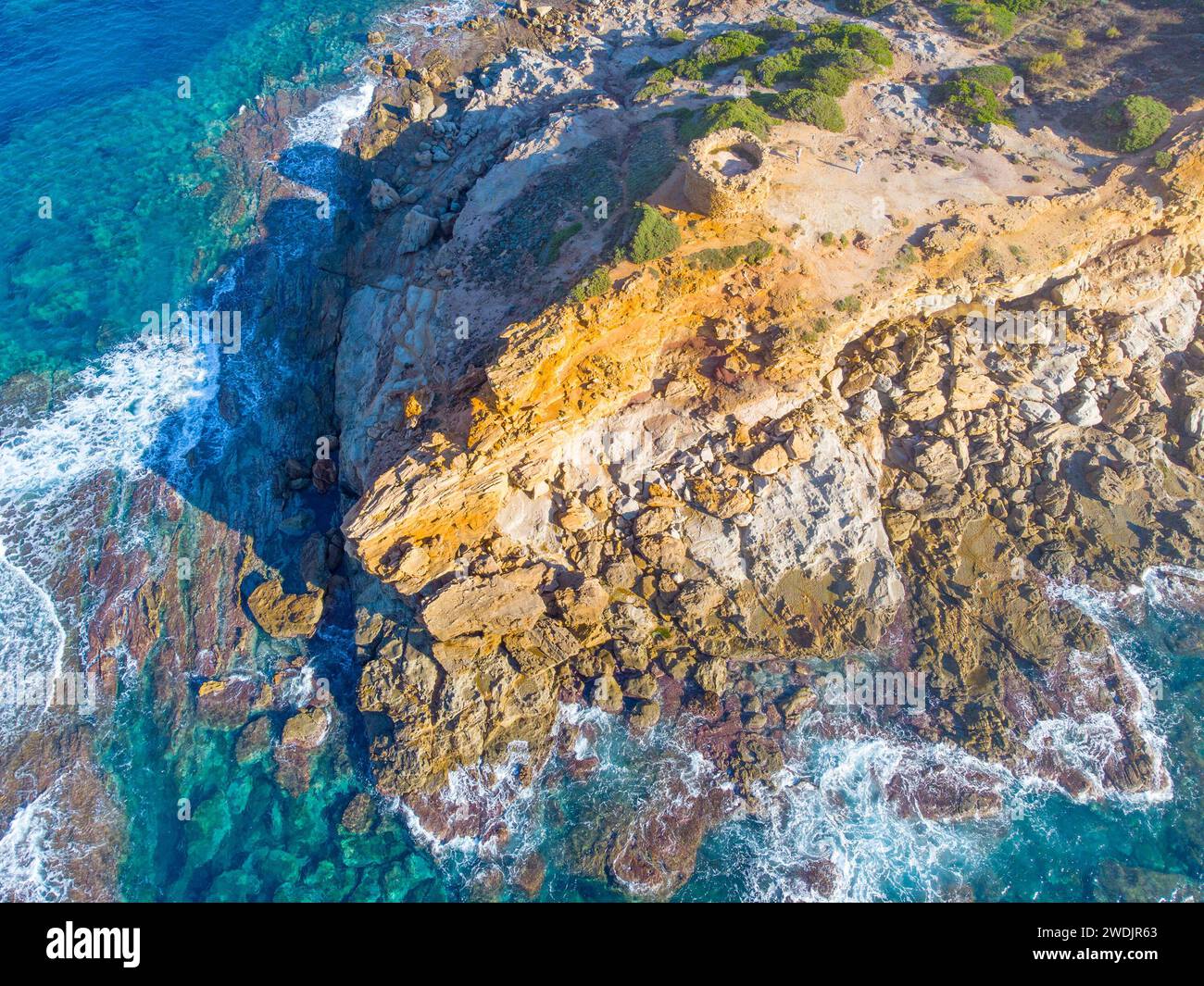 Aerial view of Porto Ferro tower surrounded by blue water. Sardinia, Italy Stock Photo