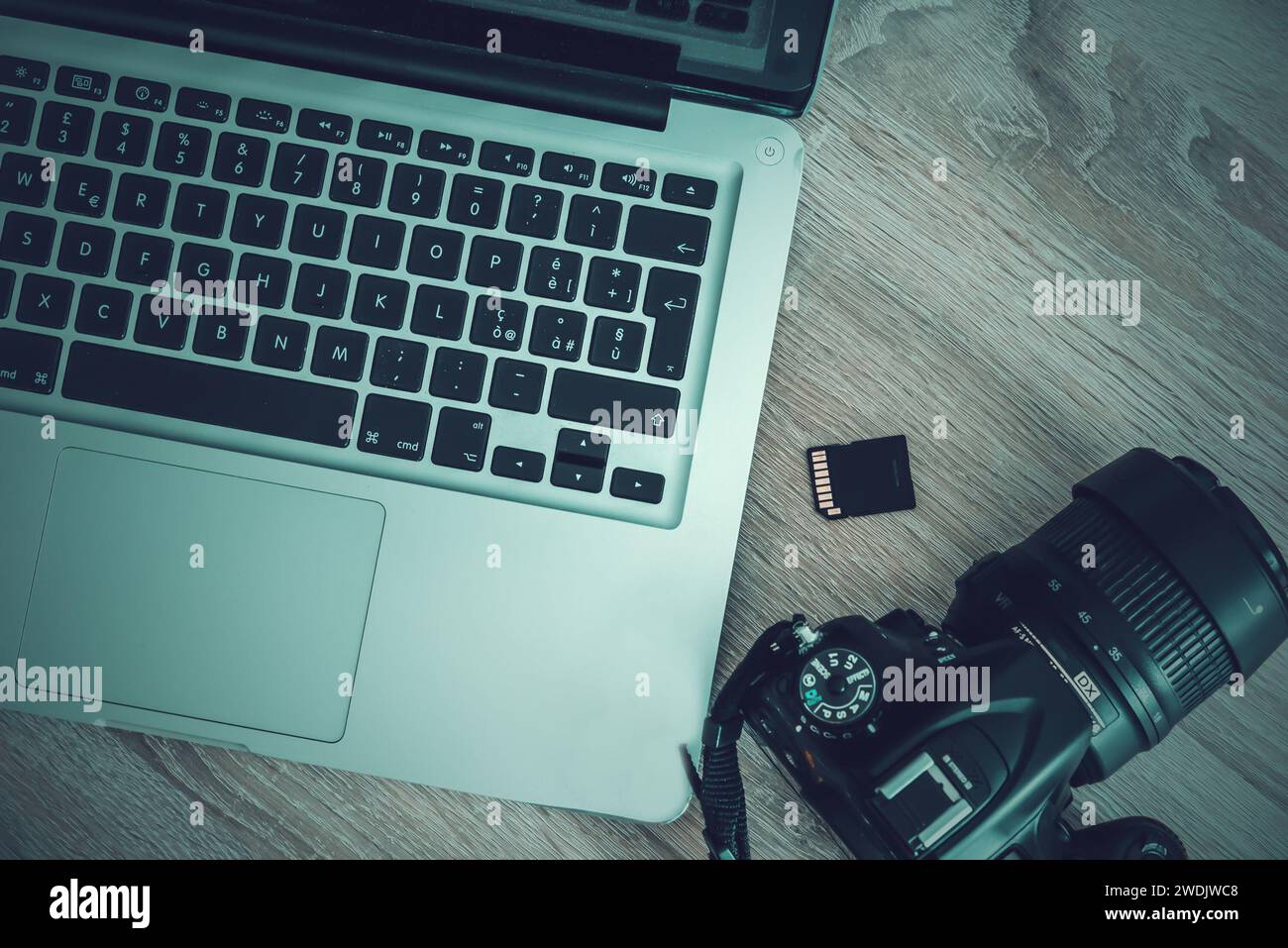 Laptop, photo camera and sd card seen from above Stock Photo - Alamy