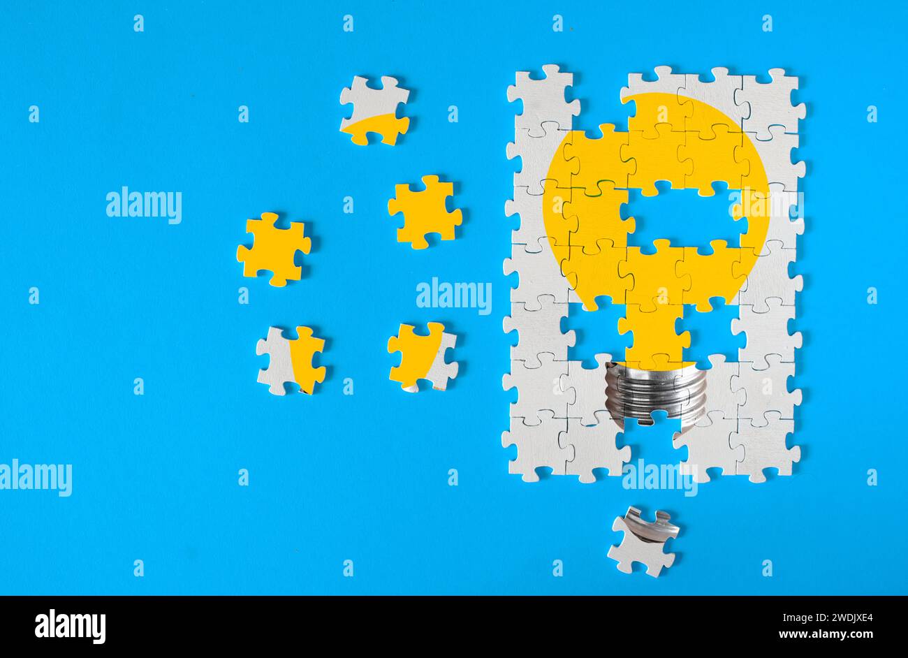 Business concept,collaboration,cooperation,teamwork,idea, innovation,human resources,recruitment,team building with jigsaw puzzle pieces and light bul Stock Photo
