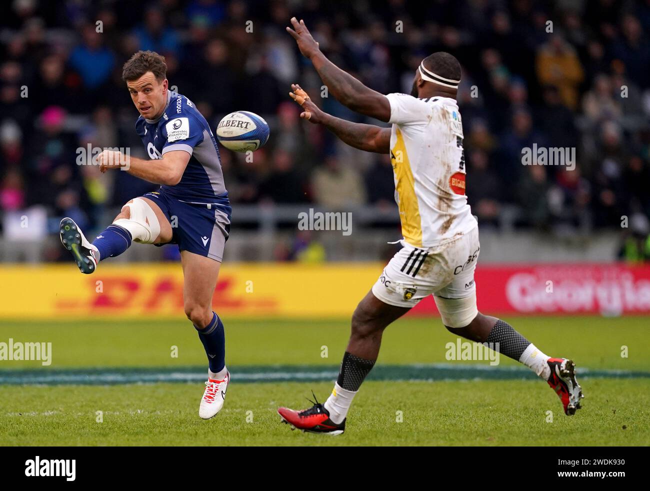 Sale Sharks' George Ford kicks the ball past La Rochelle's Levani Botia during the Investec Champions Cup pool 4 match at the AJ Bell Stadium, Salford. Picture date: Sunday January 21, 2024. Stock Photo