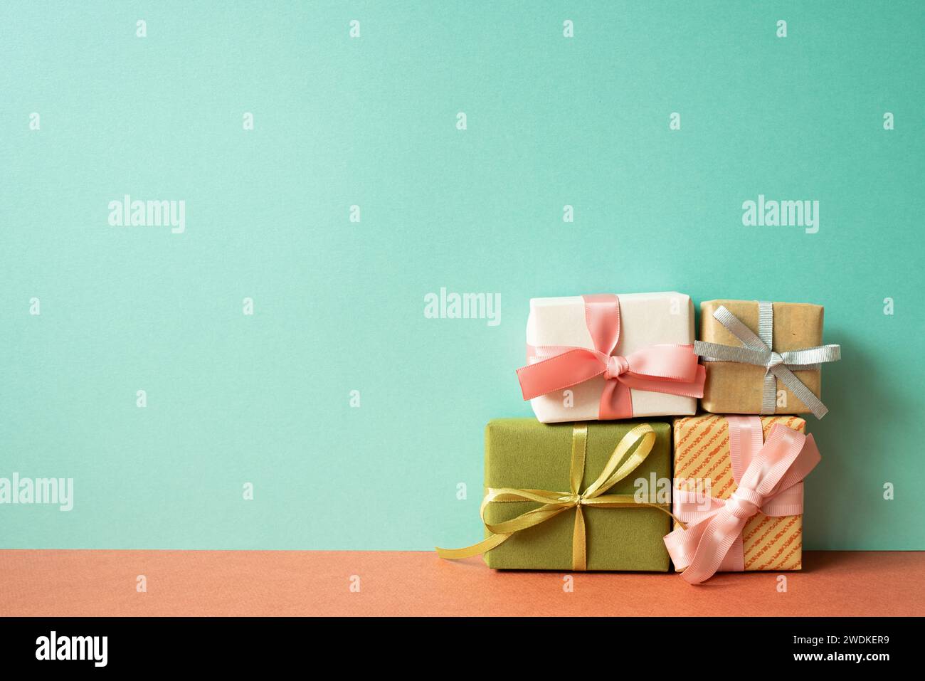 Colorful gift box on red table. mint green wall background Stock Photo