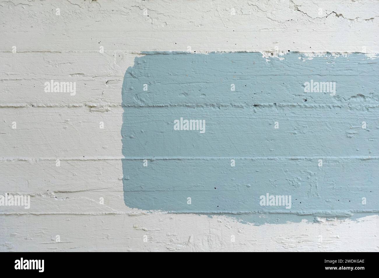 Blue rectangle painted on white concrete wall abstract background with copy space for your text. Stock Photo