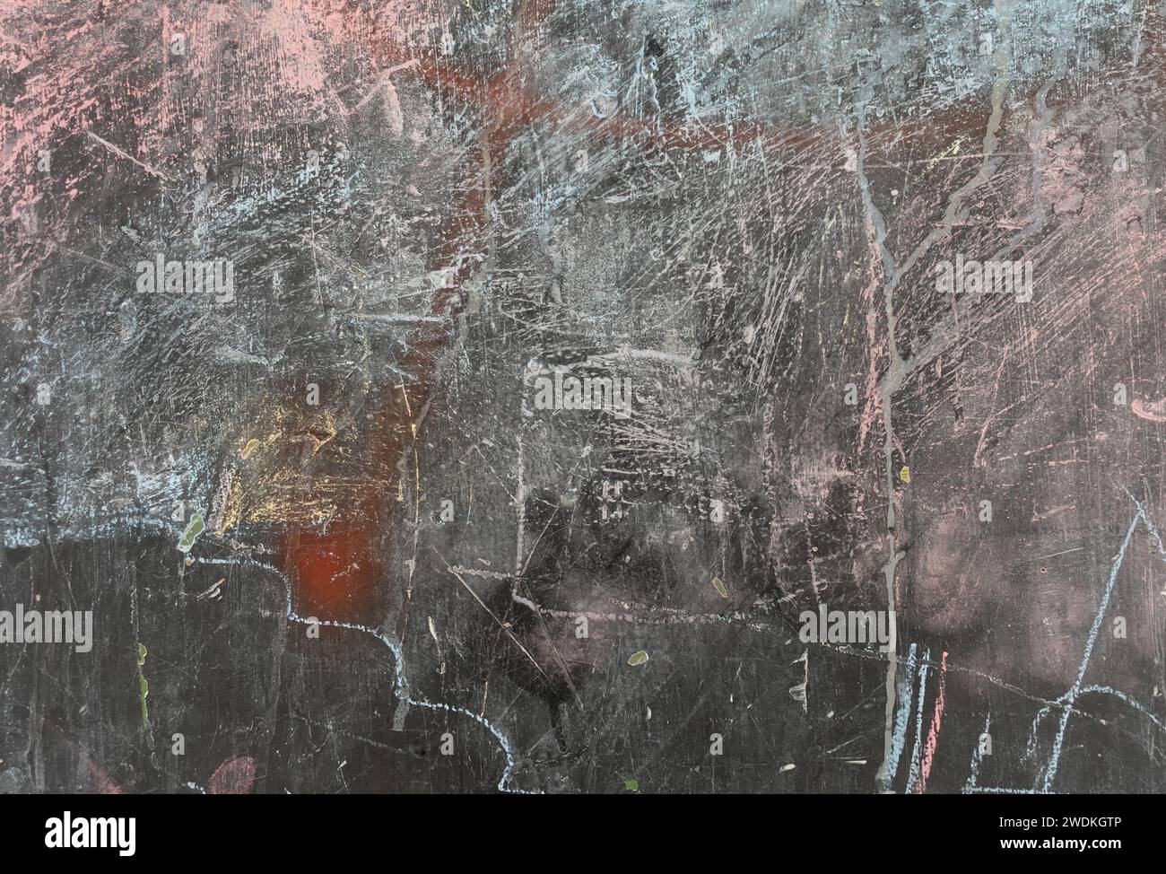 Weathered blackboard with smudged chalk stain marks and scratches. Abstract background. Stock Photo