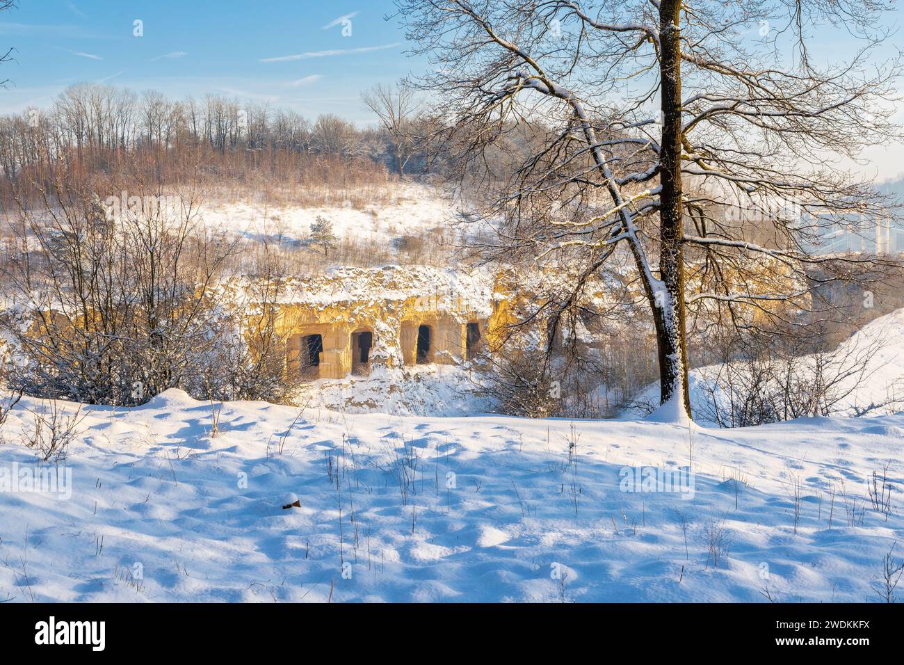 Winter view of the former ENCI marl stone quarry covered in snow just outside Maastricht with still visible remains of the industry by open holes of t Stock Photo