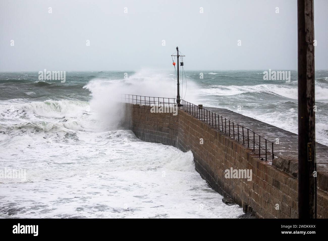 Porthleven, Cornwall, 21st January 2024, People were out walking despite the extremely strong winds in Porthleven, Cornwall. Storm Isha is forecast to arrive in the South West after 6pm this evening with strong winds overnight with a Severe weather warning from the Met Office. The Temperature was 12C. Credit: Keith Larby/Alamy Live News Stock Photo