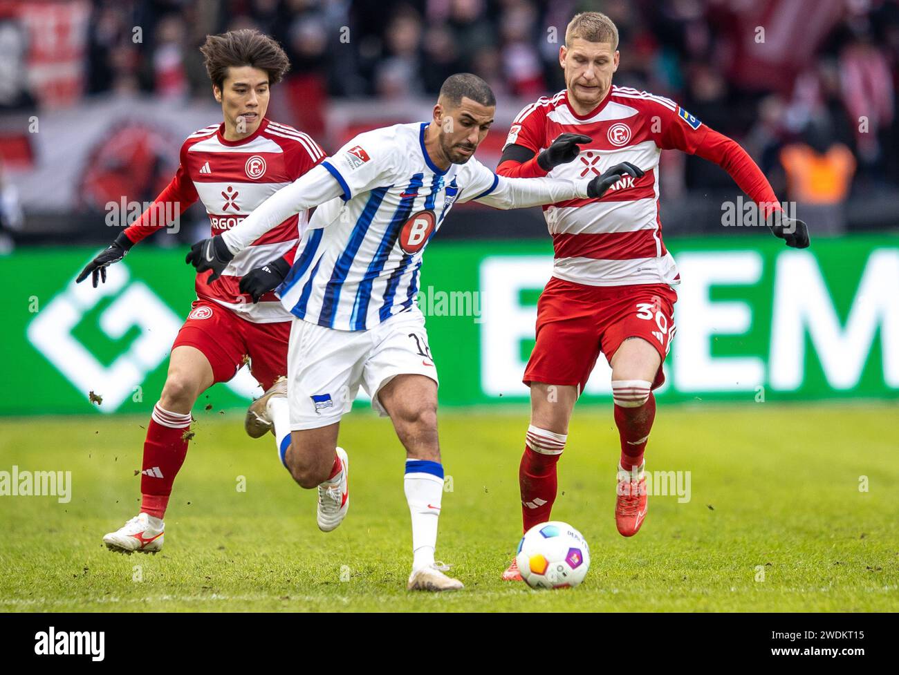 Berlin, Germany. 21st Jan, 2024. Soccer: Bundesliga 2, Hertha BSC - Fortuna Düsseldorf, Matchday 18, Olympiastadion. Berlin's Aymen Barkok (center) battles for the ball against Ao Tanaka (left) and Jordy de Wijs of Fortuna Düsseldorf. Credit: Andreas Gora/dpa - IMPORTANT NOTE: In accordance with the regulations of the DFL German Football League and the DFB German Football Association, it is prohibited to utilize or have utilized photographs taken in the stadium and/or of the match in the form of sequential images and/or video-like photo series./dpa/Alamy Live News Stock Photo