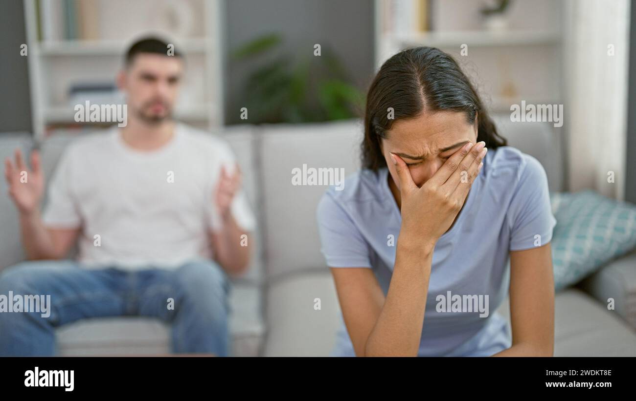 Distressed beautiful couple arguing and crying on the relaxed sofa at ...