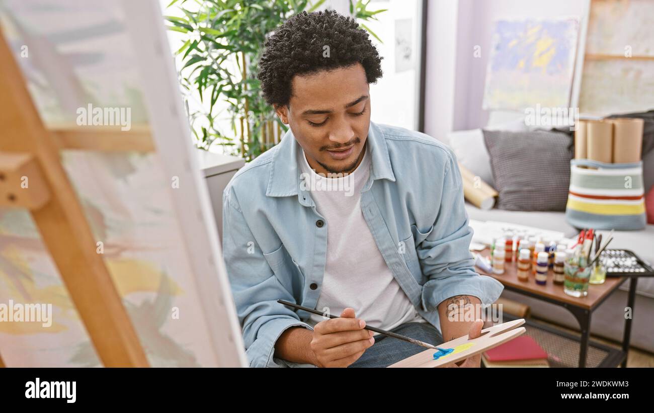 Focused young man paints hi-res stock photography and images - Alamy