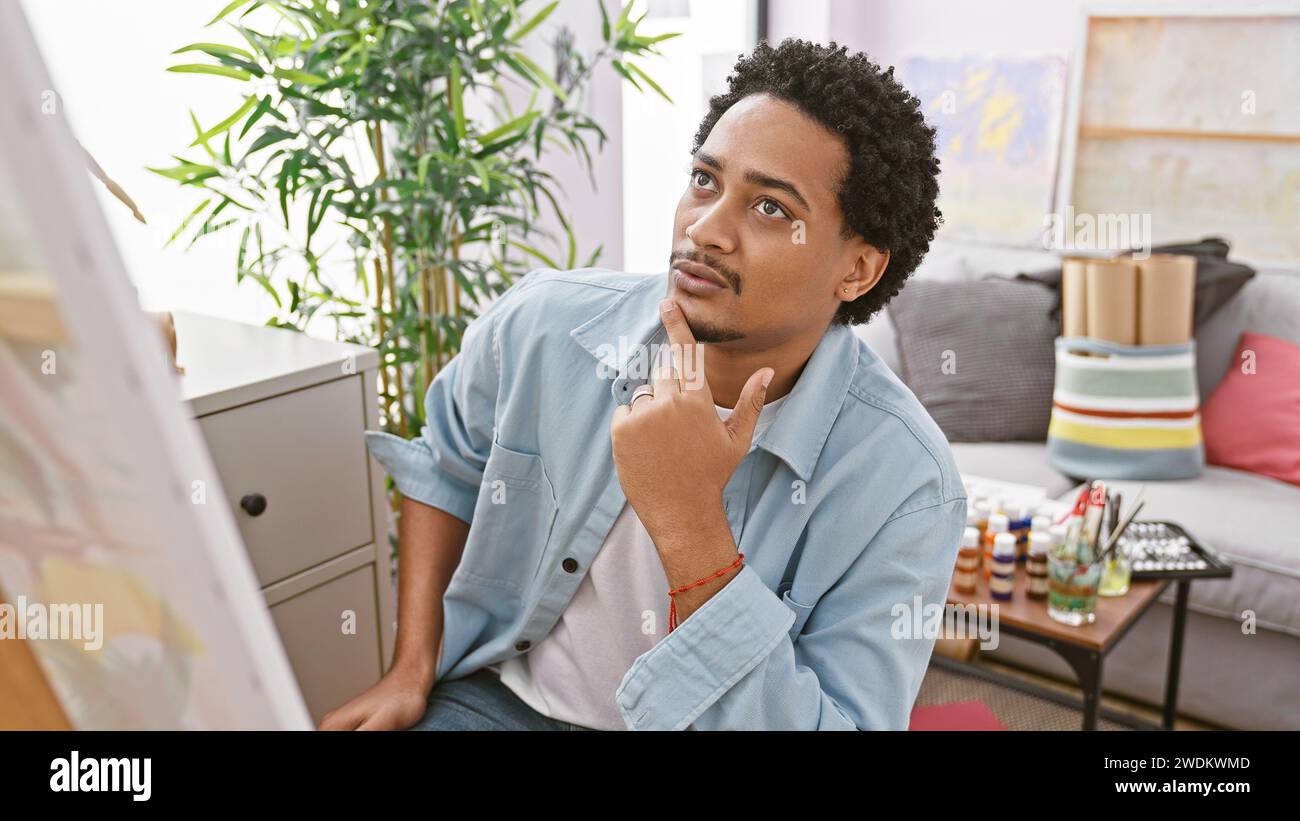 Focused young man paints hi-res stock photography and images - Alamy