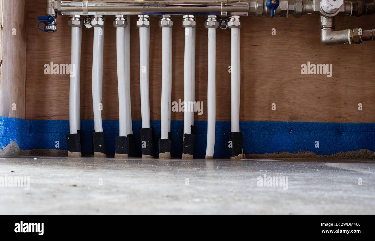 Underfloor heating pipes going into the heating manifold from the new