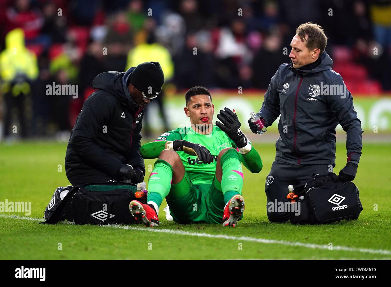 West Ham United goalkeeper Alphonse Areola receives treatment for an injury to the face after a