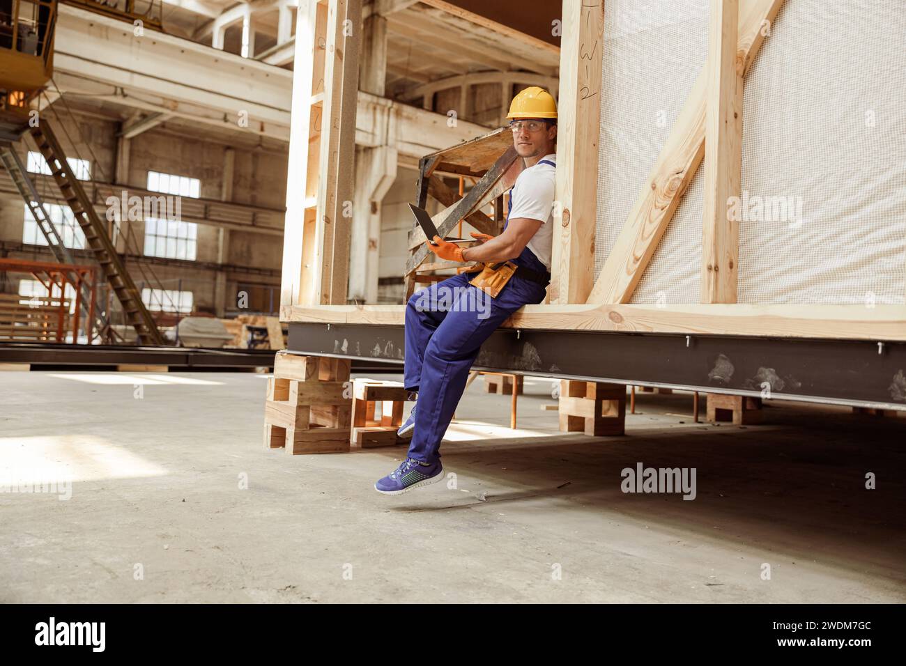 Handsome man builder using modern laptop at work Stock Photo