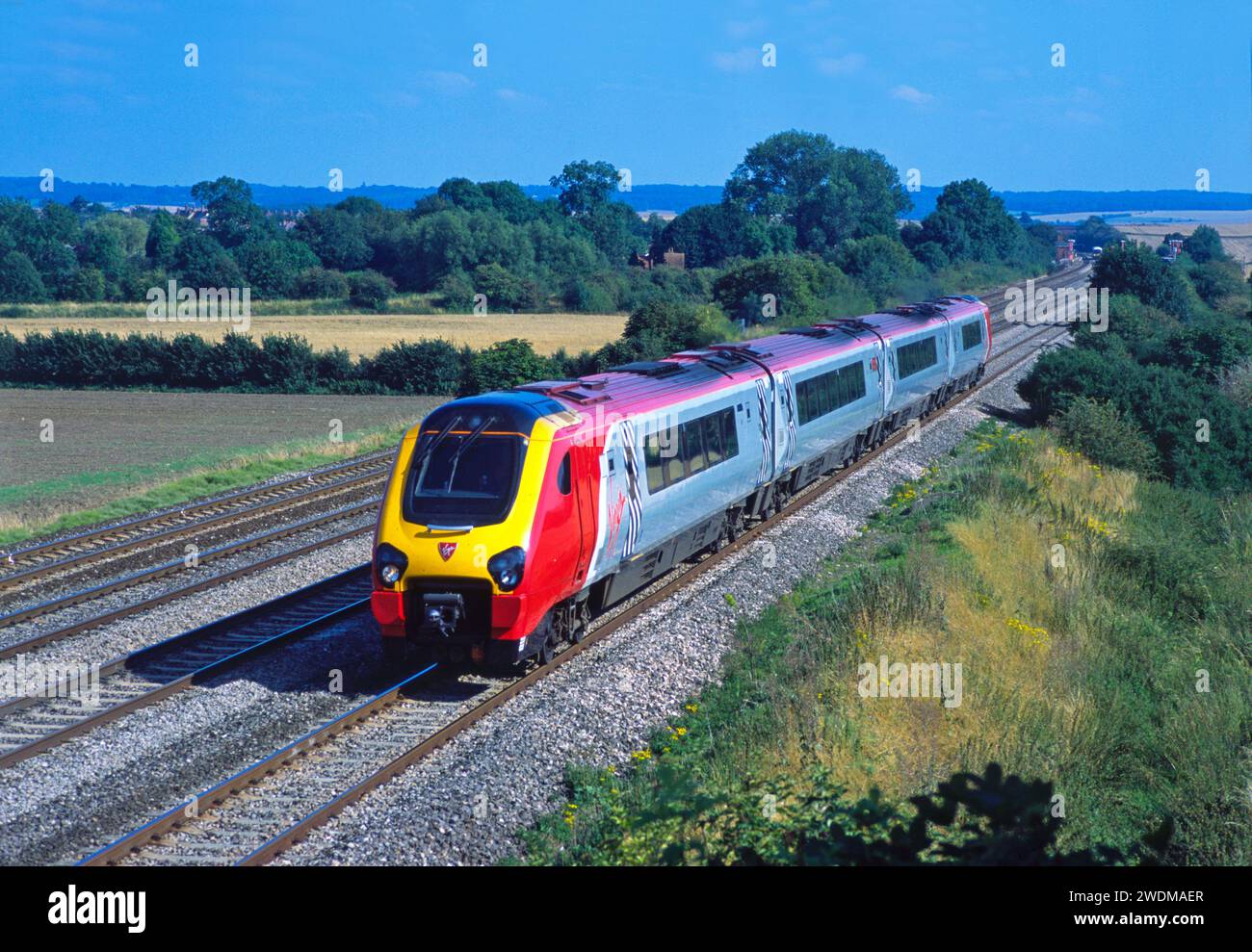 A Class 220 ‘Voyager’ diesel multiple unit number 220028 working a Virgin Cross Country service at Manor Farm near Cholsey on the 14th August 2002. Stock Photo