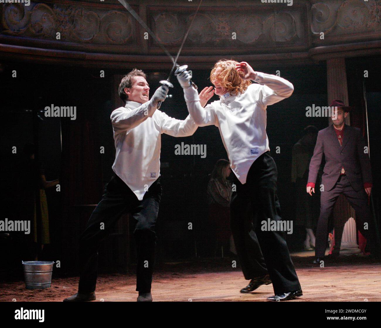 duelling - l-r: Tobias Menzies (Hamlet), Michael Shaeffer (Laertes) watched by Tom Edden (Osric) in HAMLET by Shakespeare at the Royal Theatre, Northampton, England  22/03/2005  design: Laura Hopkins  lighting: Mark Jonathan  fights: Terry King  director: Rupert Goold Stock Photo