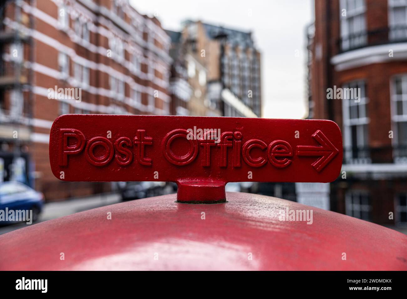 Post Office sign, on top of Victorian Post Box, in district of Marylebone, central London, England, UK Stock Photo
