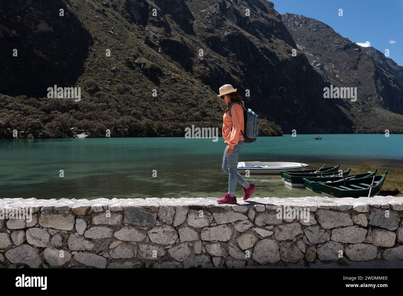 Tourist walking along the shore of the Llanganuco lagoon in the province of Huaraz, Peru. Stock Photo