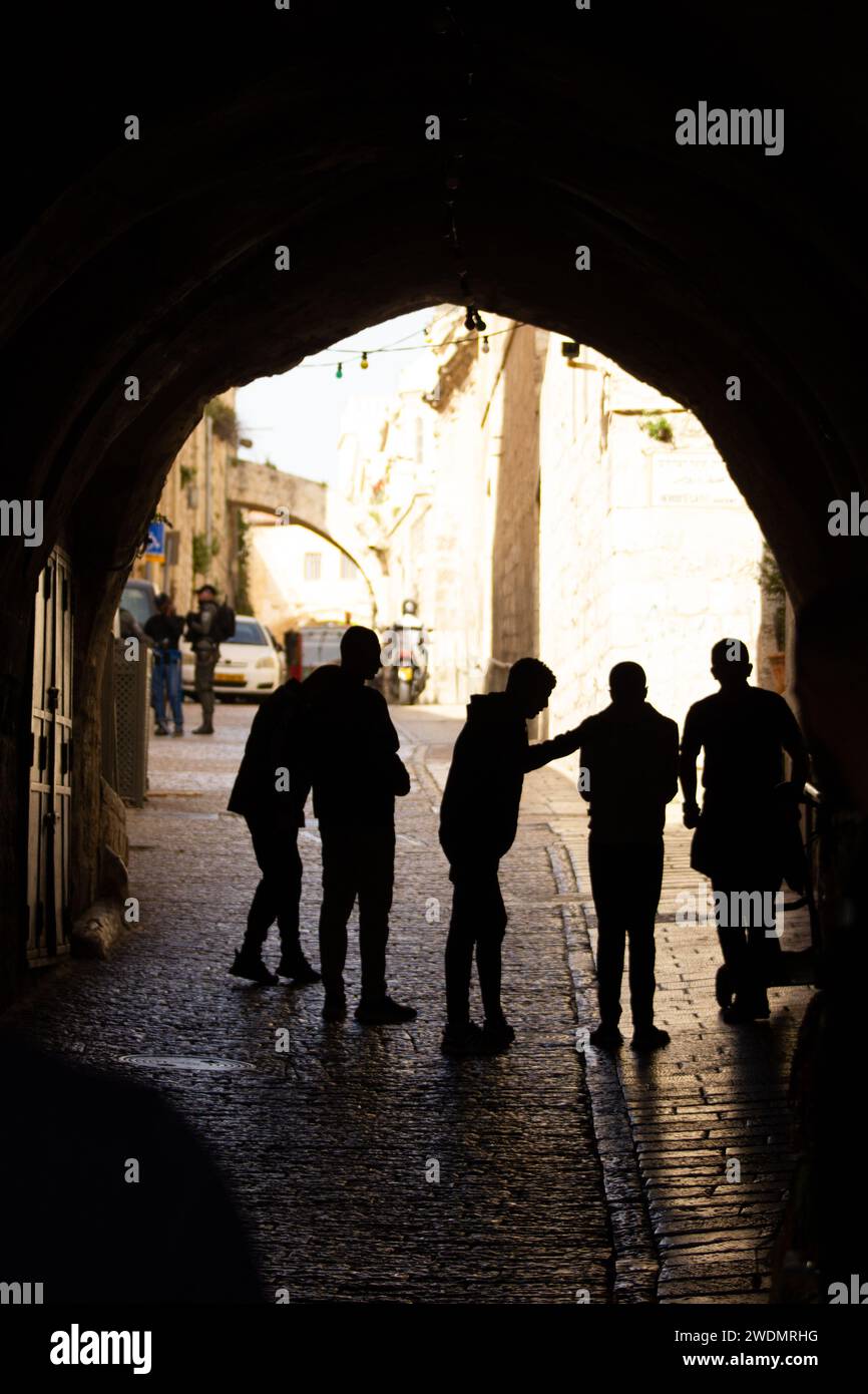 Backlit Stories: Silhouettes of People near the Lions' Gate in Jerusalem Stock Photo