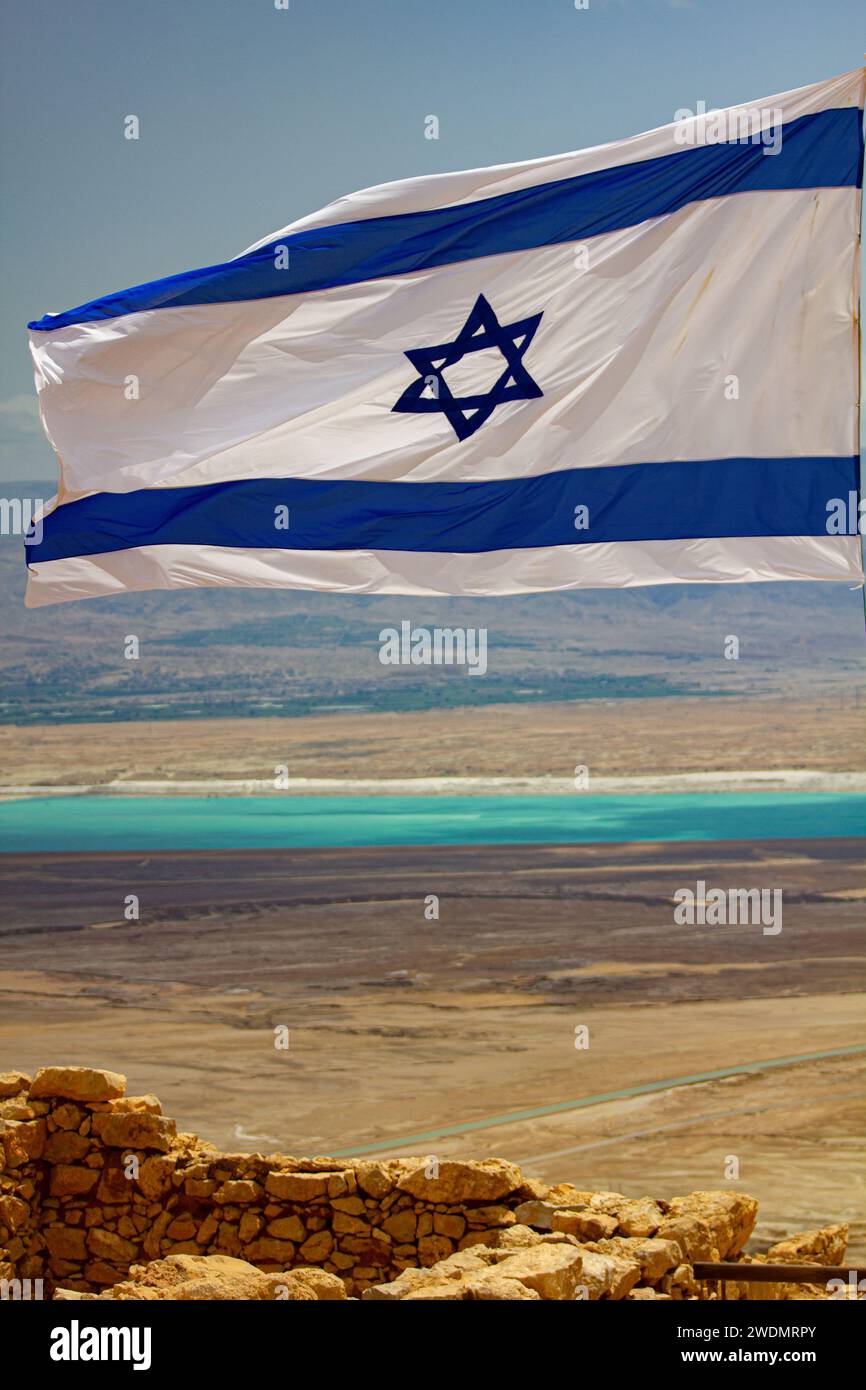 Echoes of History: Israeli Flag Waving Among the Timeless Ruins of Masada Stock Photo