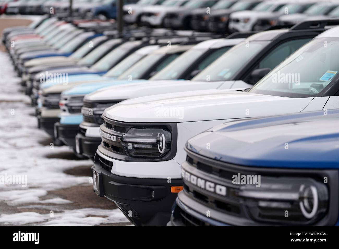 Unsold 2024 Bronco Sport models sit in a long row at a Ford dealership