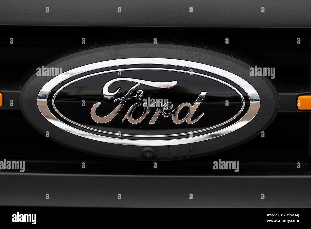 The company logo shines off the grille of an unsold 2024 F150 pickup