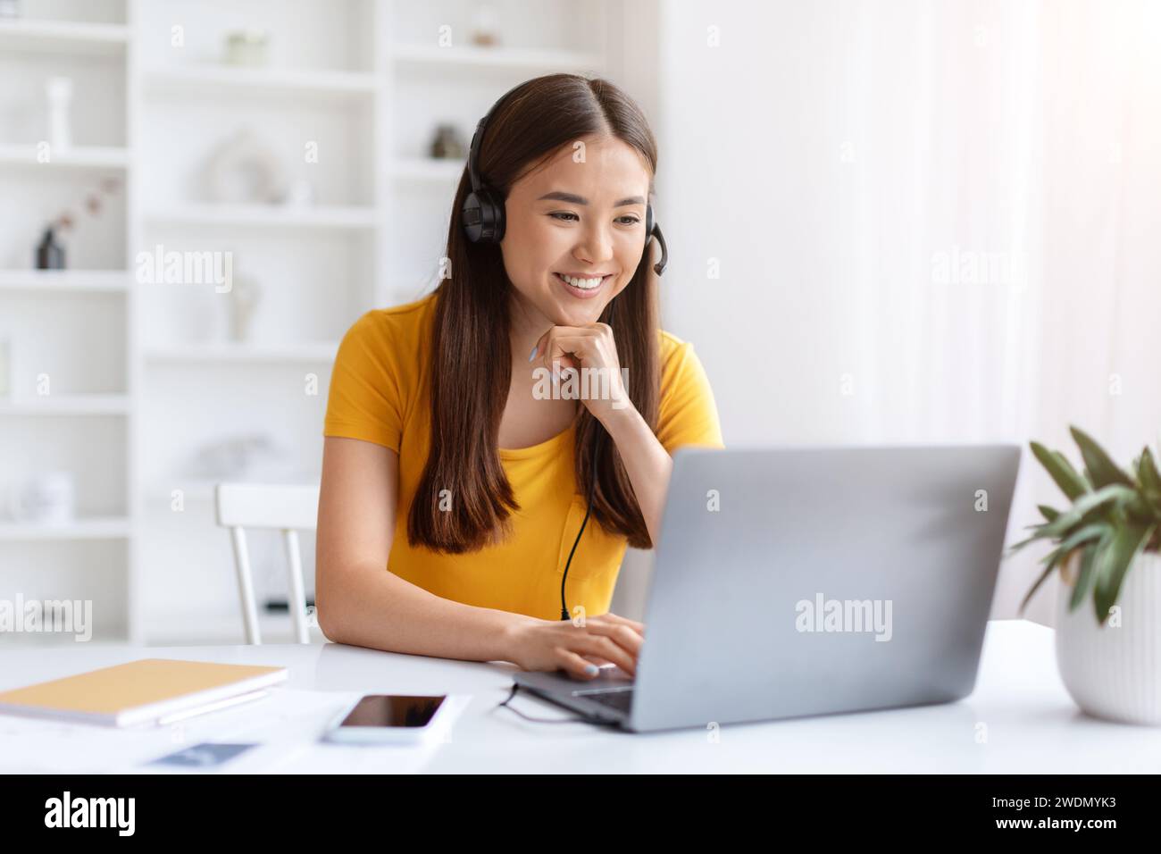 Focused young asian woman headset hi-res stock photography and images ...