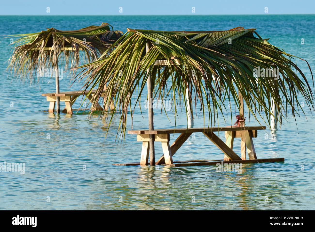 The infamous Secret Beach, a hot spot for tourists, with tables in the