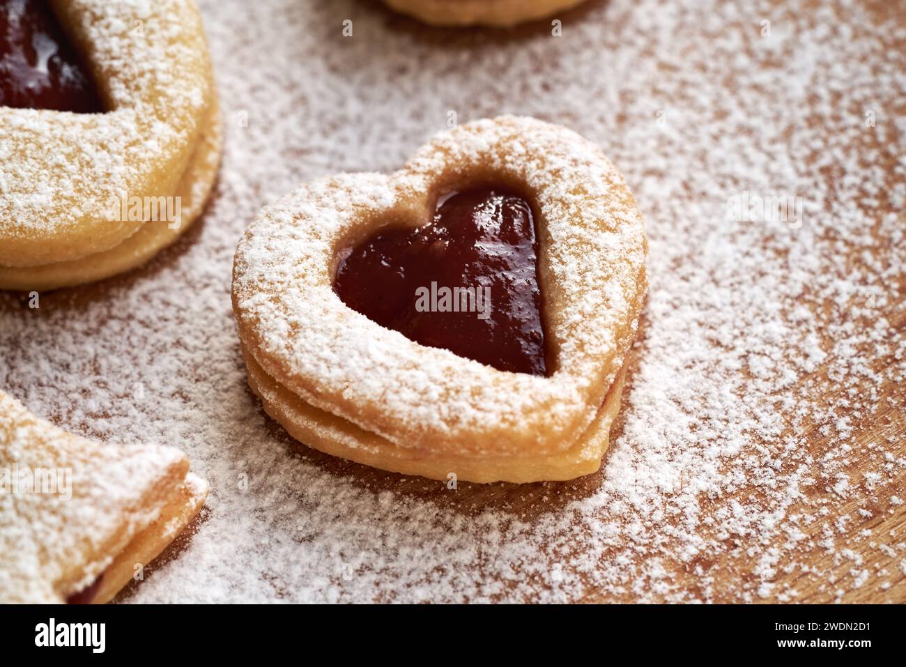 Heart shaped Linzer Christmas cookies filled with strawberry marmalade, dusted with sugar Stock Photo