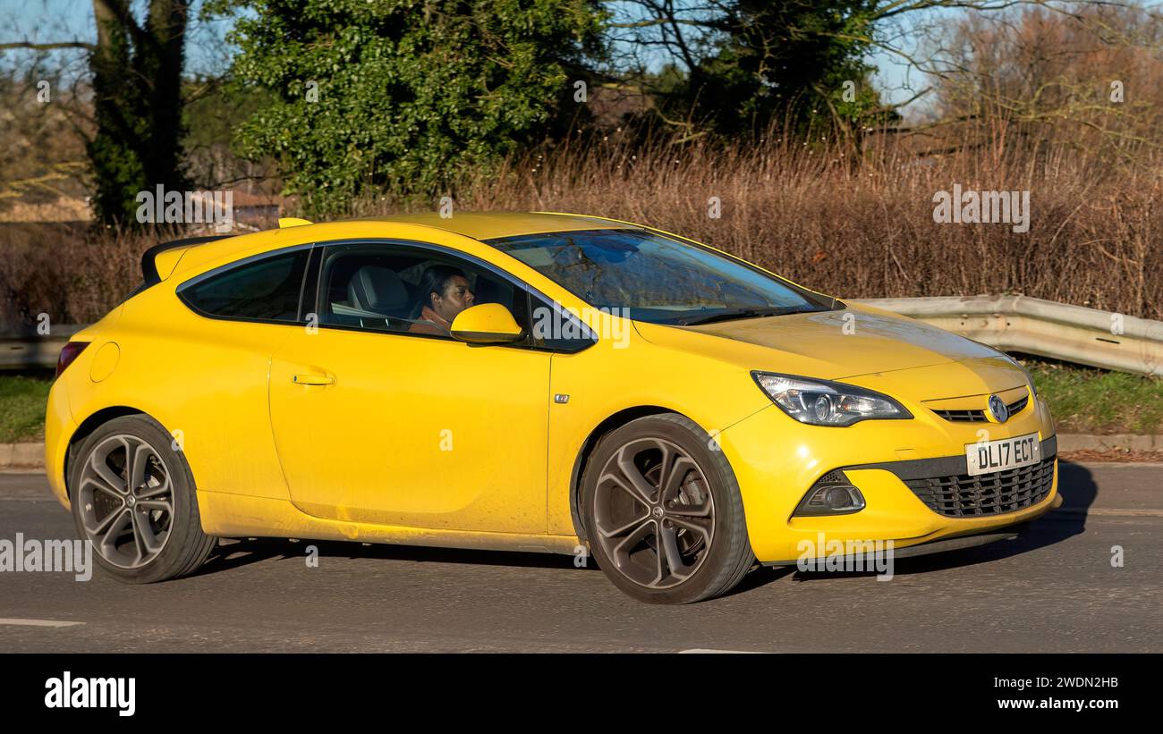 Milton Keynes,UK-Jan 18th 2024: 2017 yellow Vauxhall Astra driving on a bright,sunny winter's day Stock Photo