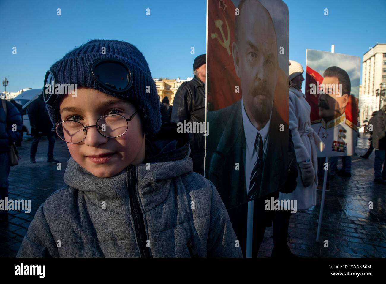 Moscow, Russia. 21st of January, 2024. Russian Communist supporters carry portraits of Vladimir Lenin and Joseph Stalin as they walk to lay flowers at the Mausoleum of the Soviet founder Vladimir Lenin to mark the 100th anniversary of his death, in Red Square, Moscow, Russia. Credit: Nikolay Vinokurov/Alamy Live News Stock Photo