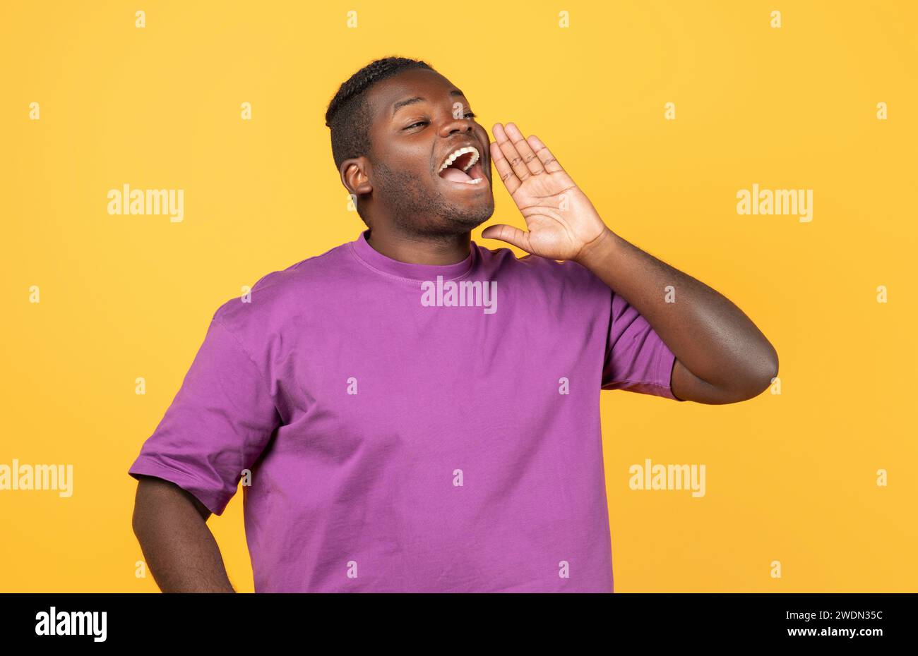 Black Guy Shouting Looking Aside Holding Hand Near Mouth, Studio Stock Photo