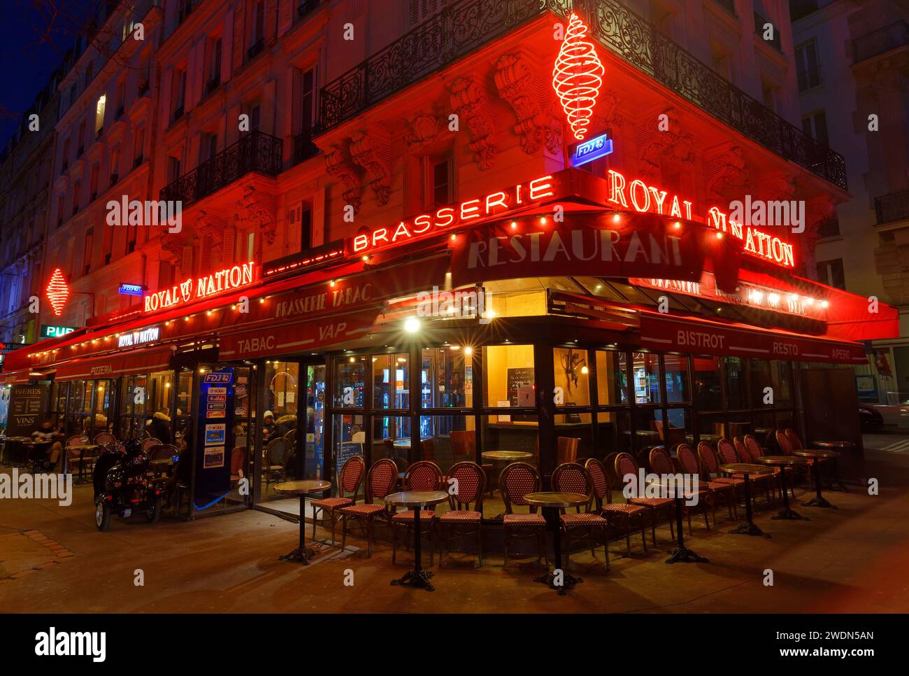 The traditional French cafe brasserie Royal Nation at night.It is ...
