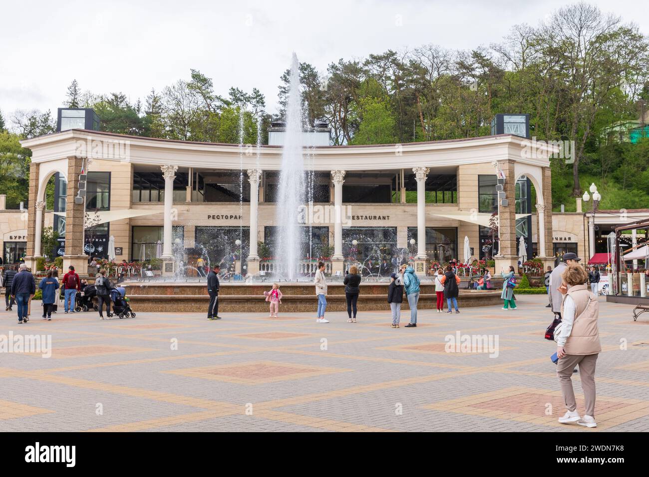 Kislovodsk, Russia - May 9, 2023: Kurortny Boulevard street view, people walk near the fountain in front of the Restaurant 5642 Height Stock Photo