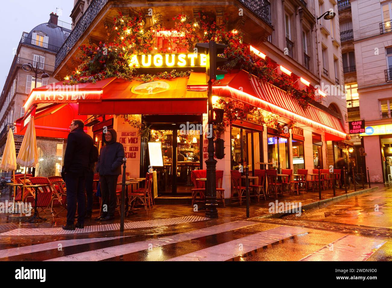 The traditional French cafe Auguste decorated with flowers at rainy ...