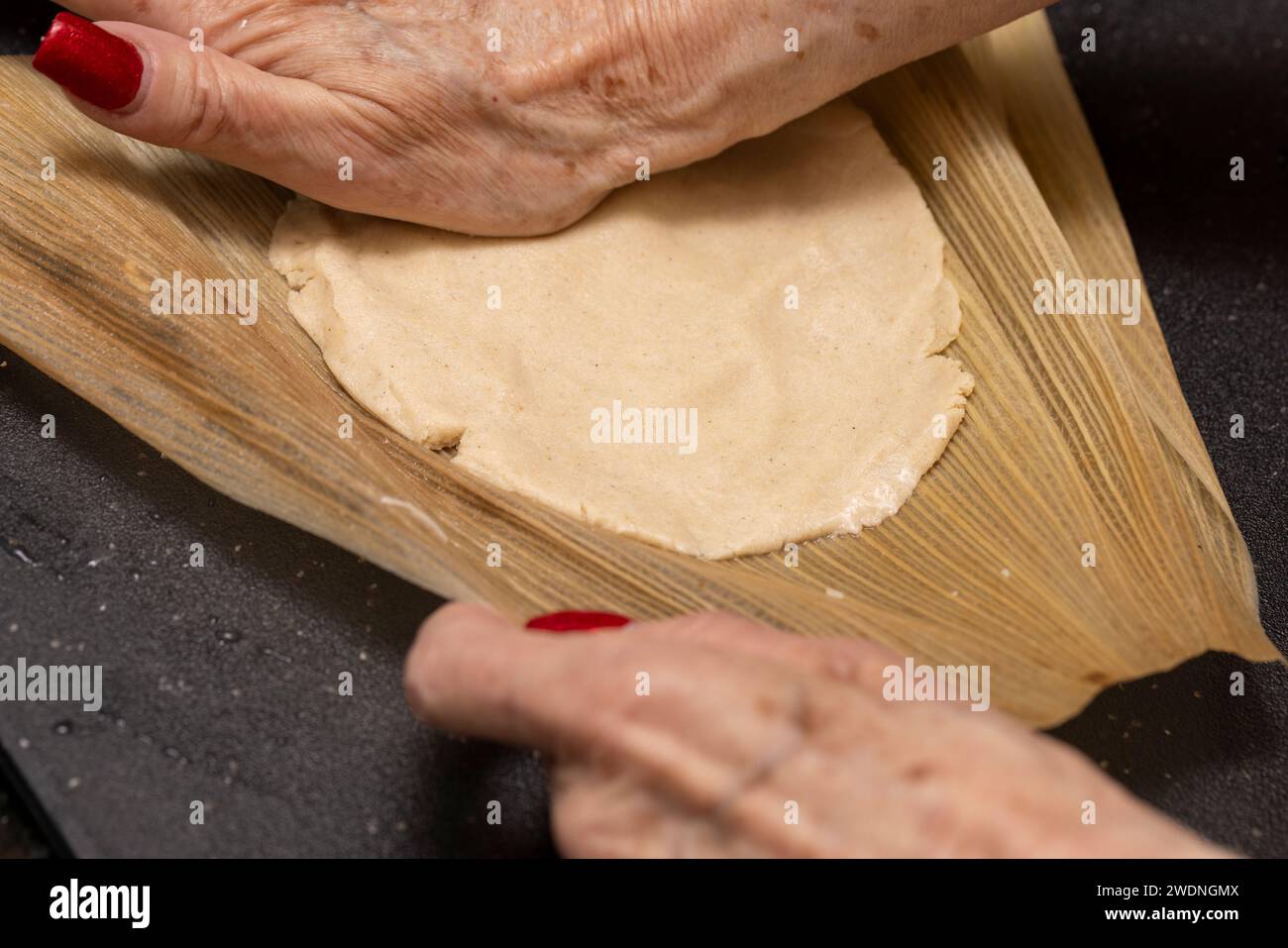 Process of making homemade red ancho chili tamales assembled on corn