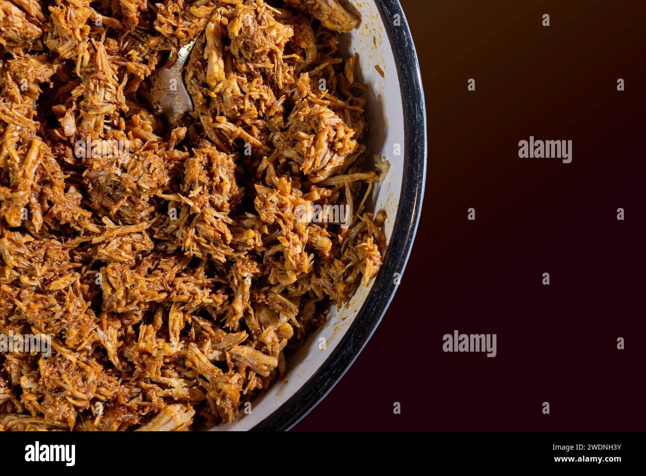 Bowl of red ancho chili pulled pork ready to fill tamales or burritos