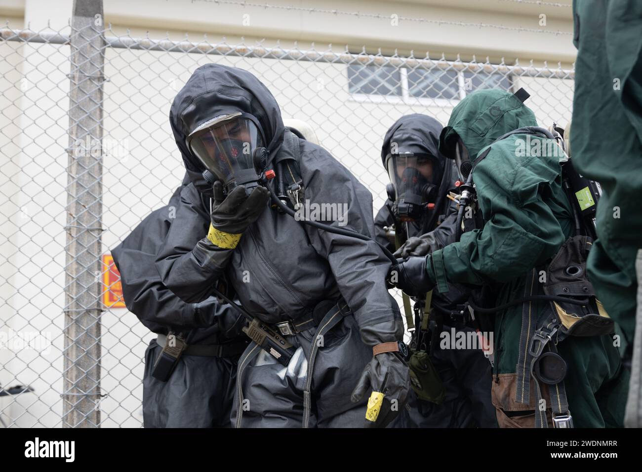 U.S. Marine Corps chemical, biological, radioactive, and nuclear defense specialists with the command element, 31st Marine Expeditionary Unit, conduct simulated decontamination during a chemical response exercise at Camp Hansen, Okinawa, Japan, Jan. 17, 2024. CREEX tests CBRN’s capabilities to respond to different operations, including clandestine labs, containing chemical munitions, and countering weapons of mass destruction while performing reconnaissance, decontamination, and rapid insertion for casualties. The 31st MEU, the Marine Corps’ only continuously forward-deployed MEU, provides a f Stock Photo