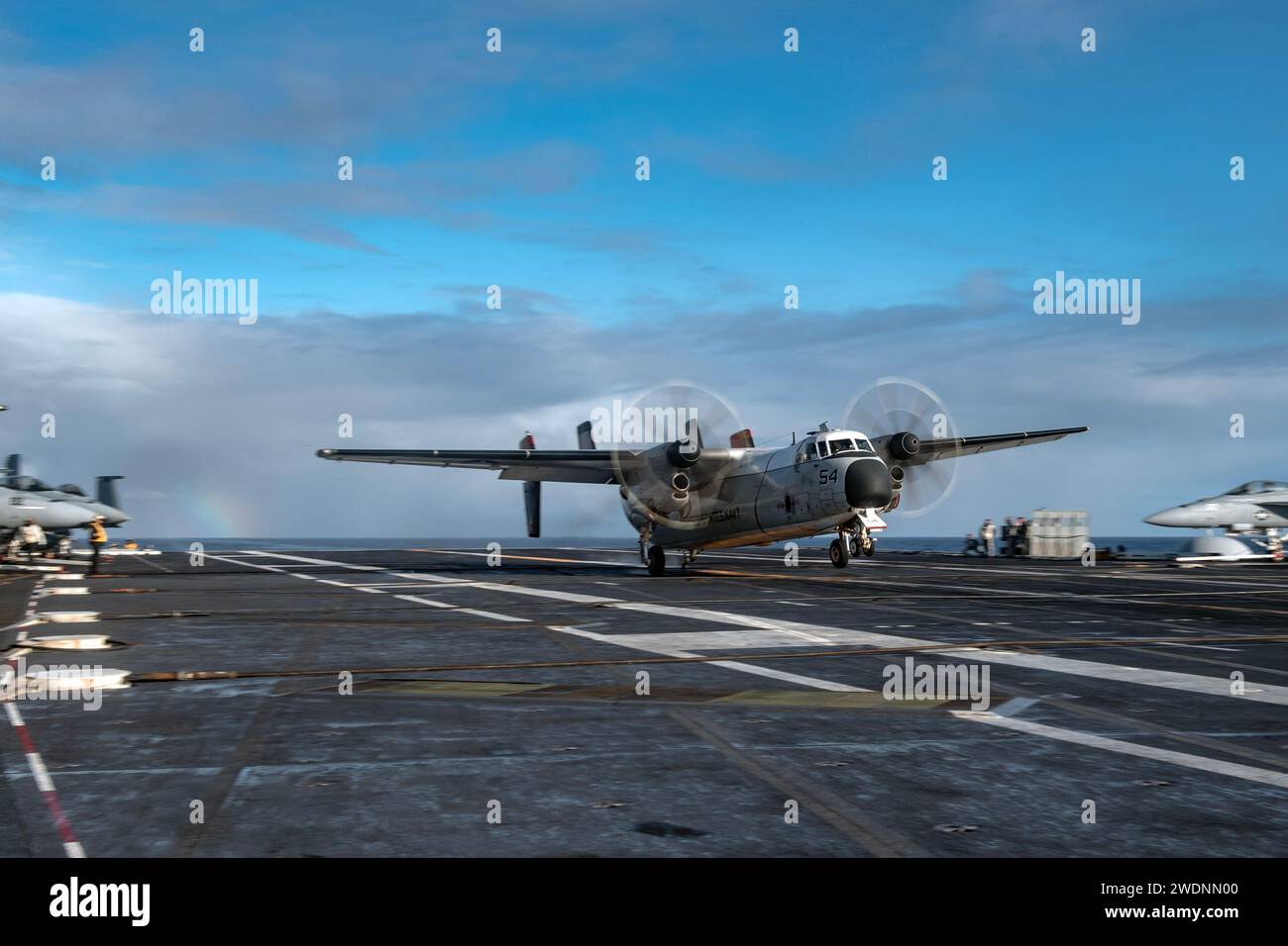 PACIFIC OCEAN (Jan. 18, 2024) A C-2A Greyhound, assigned to the “Rawhides” of Fleet Logistics Support Squadron (VRC) 40, lands on the flight deck of the Nimitz-class aircraft carrier USS Theodore Roosevelt (CVN 71), Jan. 18, 2024. Theodore Roosevelt, flagship of Carrier Strike Group Nine, is underway conducting routine operations in the U.S. 3rd Fleet area of operations. An integral part of U.S. Pacific Fleet, U.S. 3rd Fleet operates naval forces in the Indo-Pacific and provides the realistic, relevant training necessary to execute the U.S. Navy’s role across the full spectrum of military oper Stock Photo