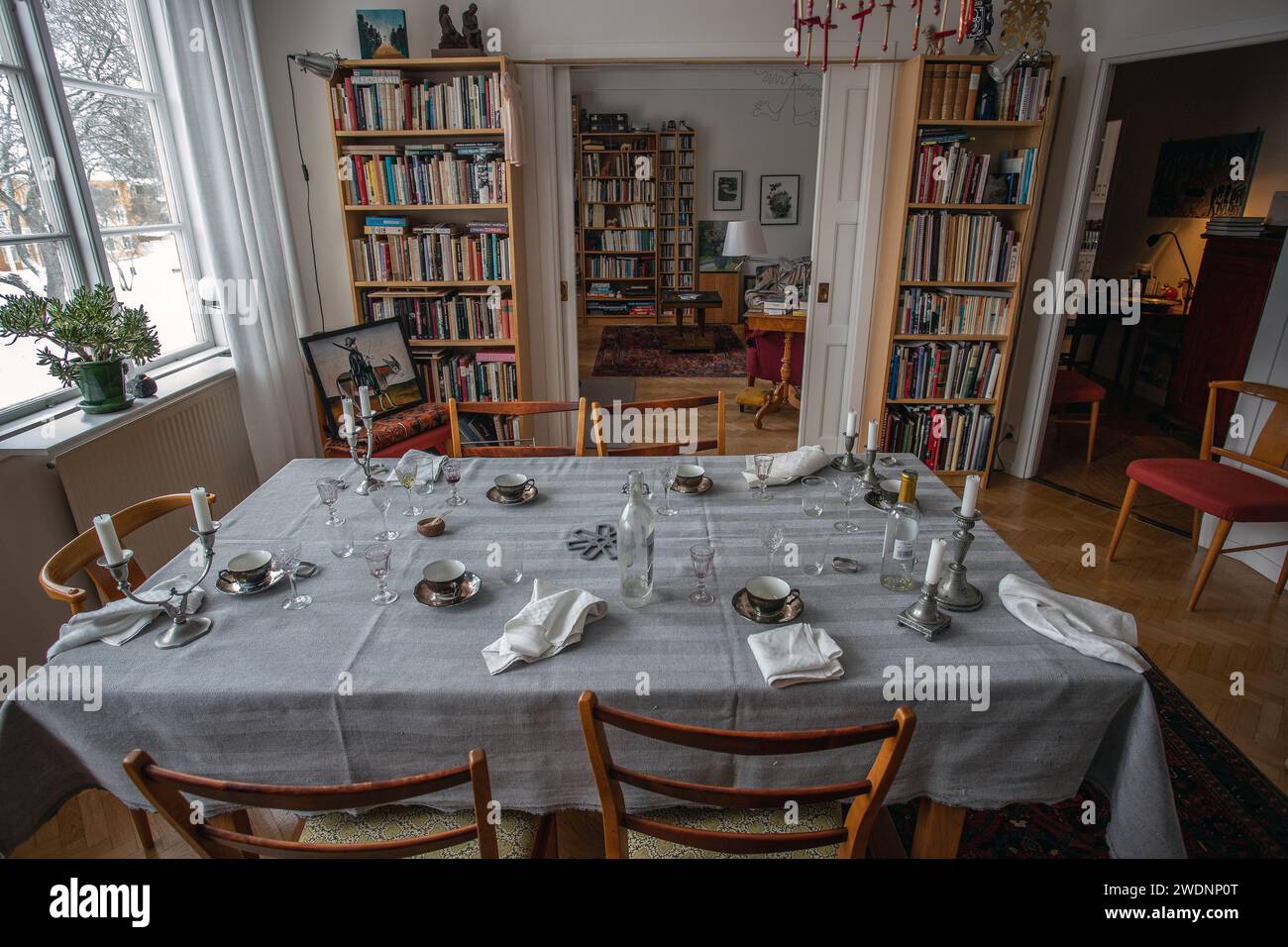 The party is over. Dinner table after party. Empty plate after dinner. Dinner set for home event. Dirty table after banquet. Celebration at home. Stock Photo