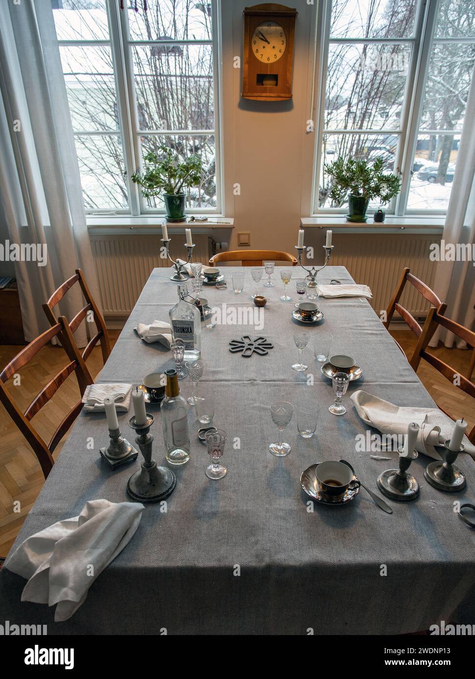 The party is over. Dinner table after party. Empty plate after dinner. Dinner set for home event. Dirty table after banquet. Celebration at home. Stock Photo