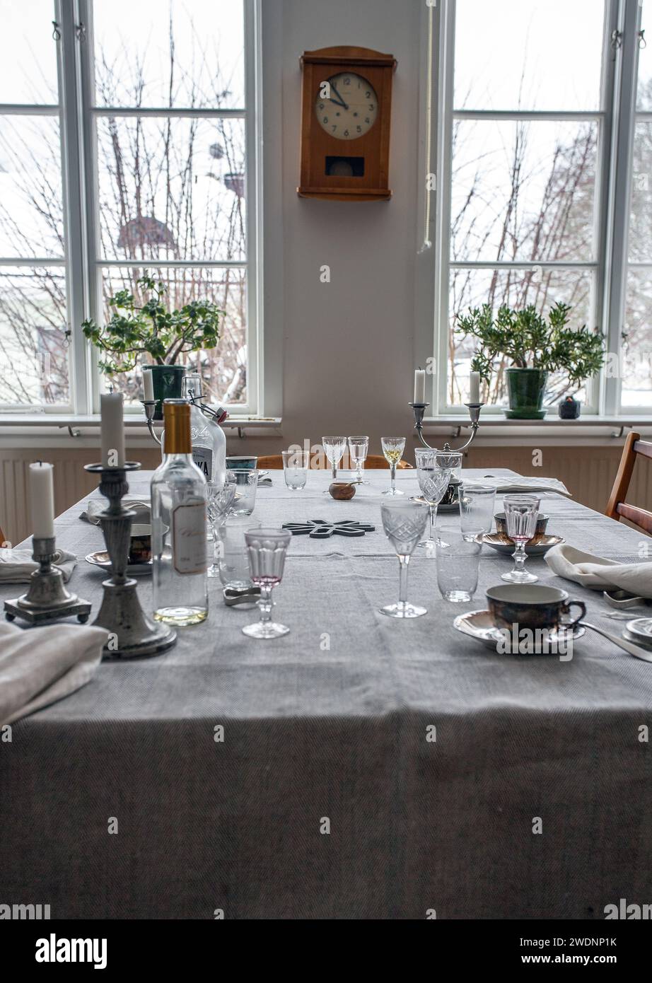 The party is over. Dinner table after party. Empty plate after dinner. Dinner set for home event. Dirty table after banquet. Celebration at home. Stock Photo