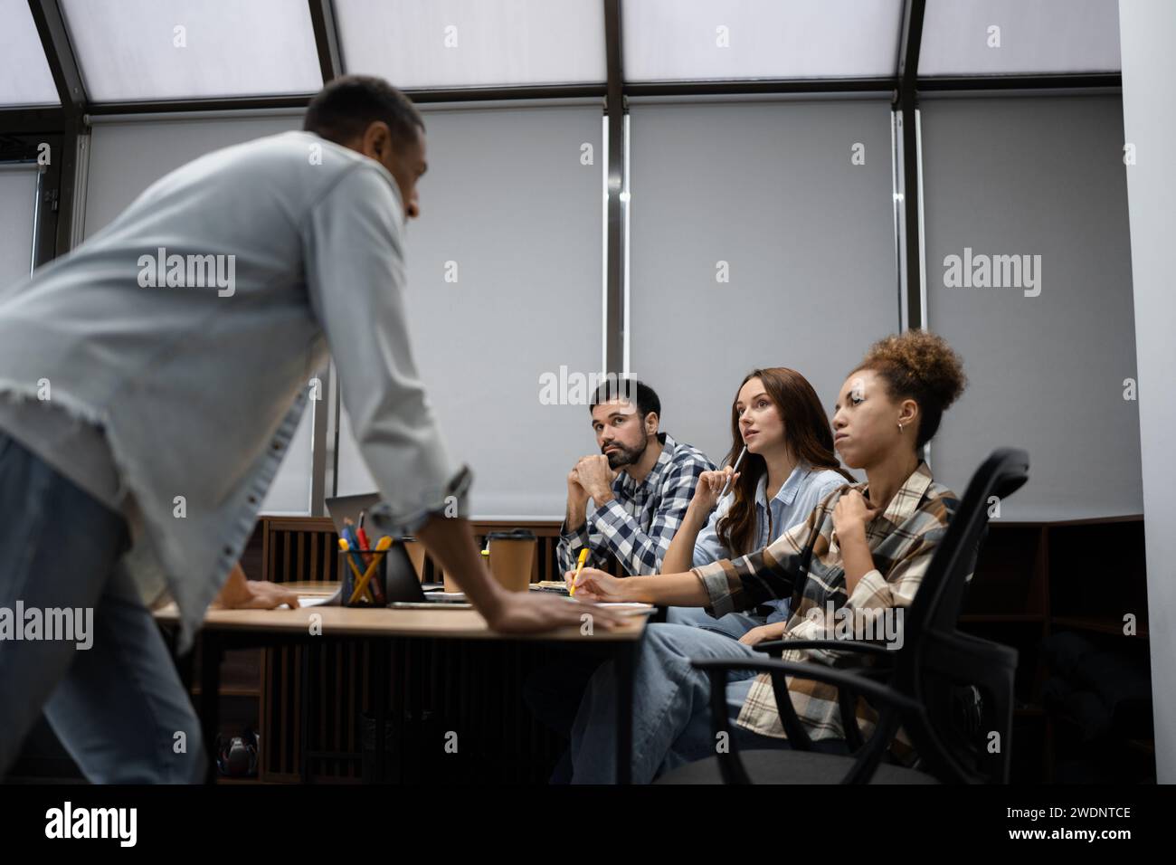 Group of diverse businesspeople using a laptop while working together ...