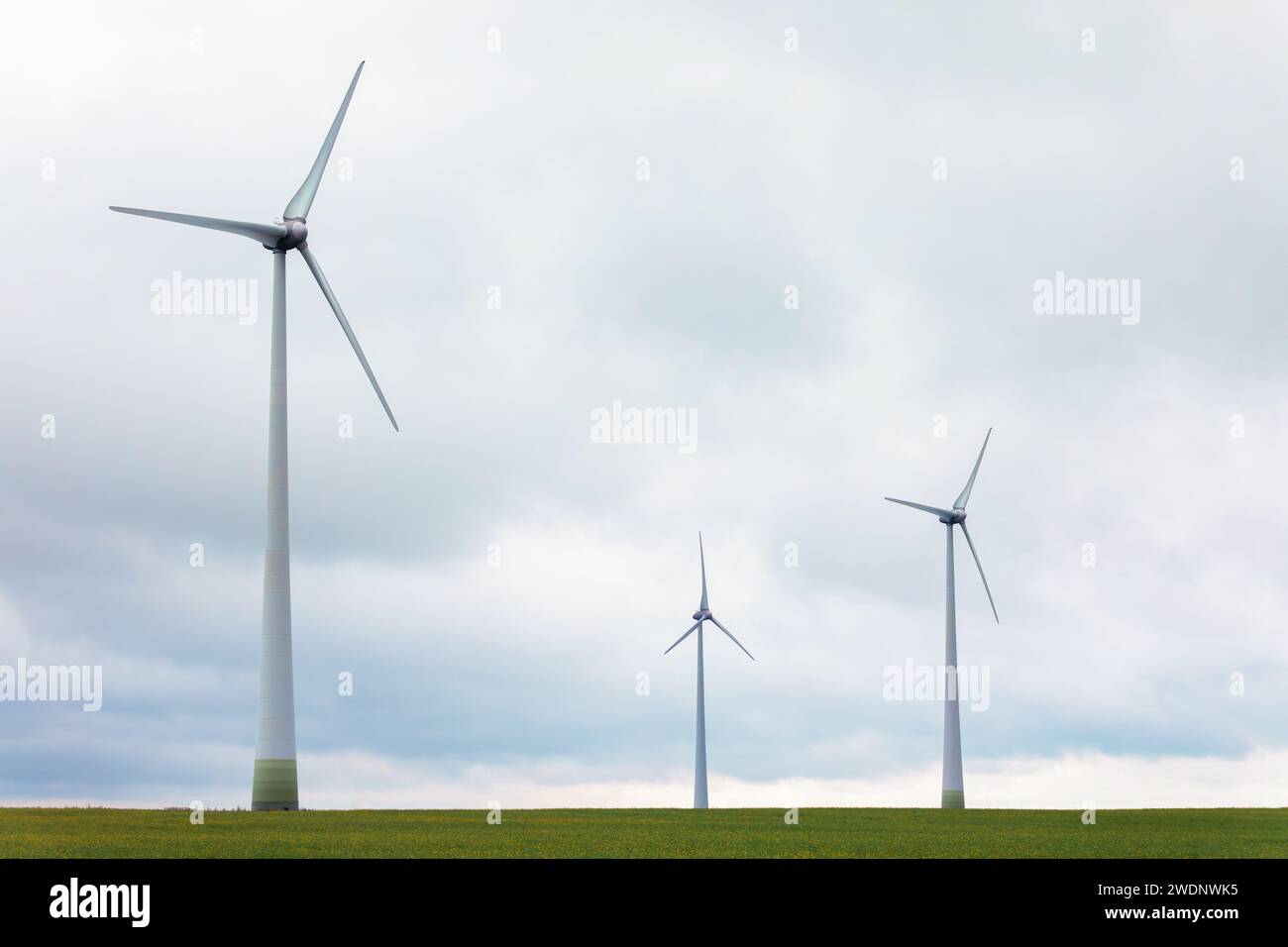 Wind turbine in countryside landscape with light cloudy sky. Stock Photo