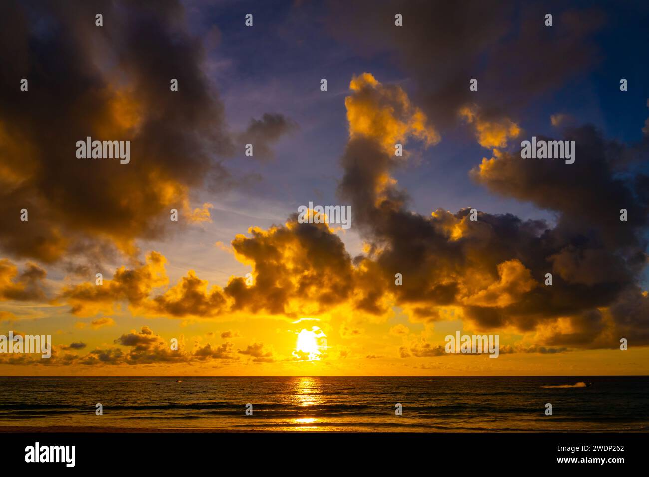 Beautiful colorful sunset or sunrise sky over sea with dramatic clouds ...