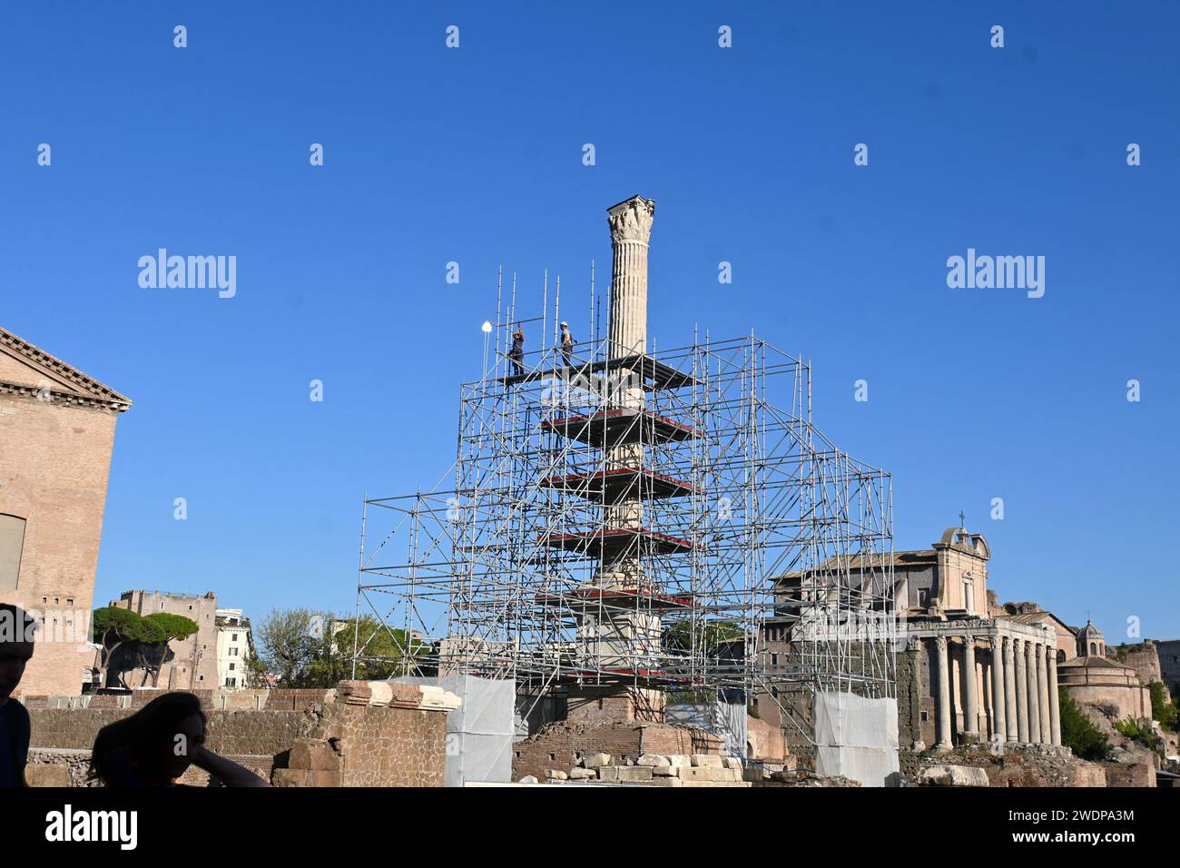 Workers on scaffolding doing repairs to a column in the Roman Forum – Rome, Italy – October 31 2022 Stock Photo