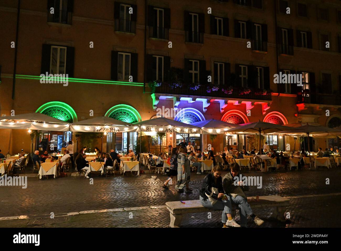 Piazza Navona, Restaurant colours light up the square at night-- Rome, Italy – 2 November 2022 Stock Photo
