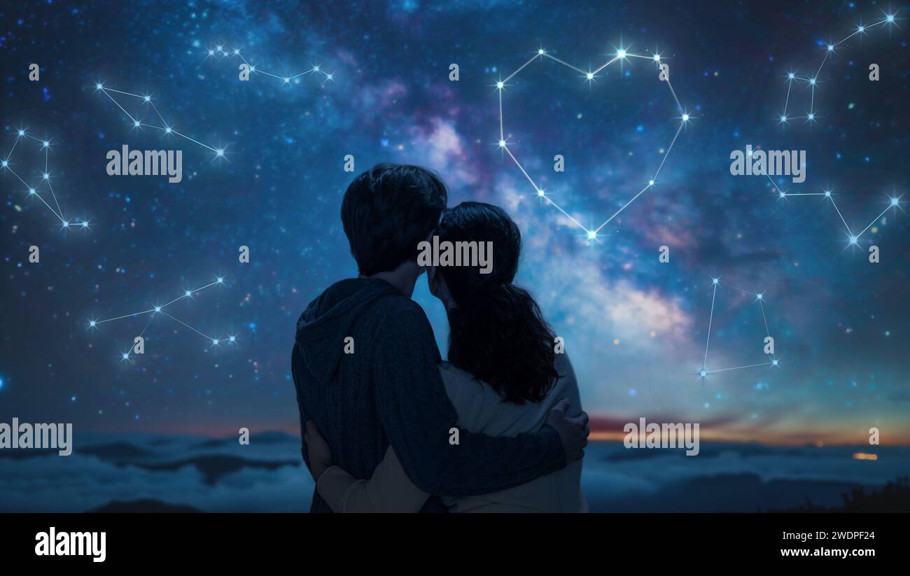 A couple in love looking at the starry sky. A fantasy constellation in the shape of a heart. Stock Photo