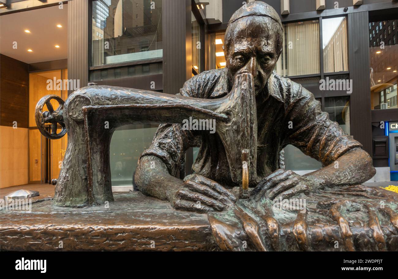 statue of a man sewing on a sewing machine in the garment district of Manhattan NYC Stock Photo